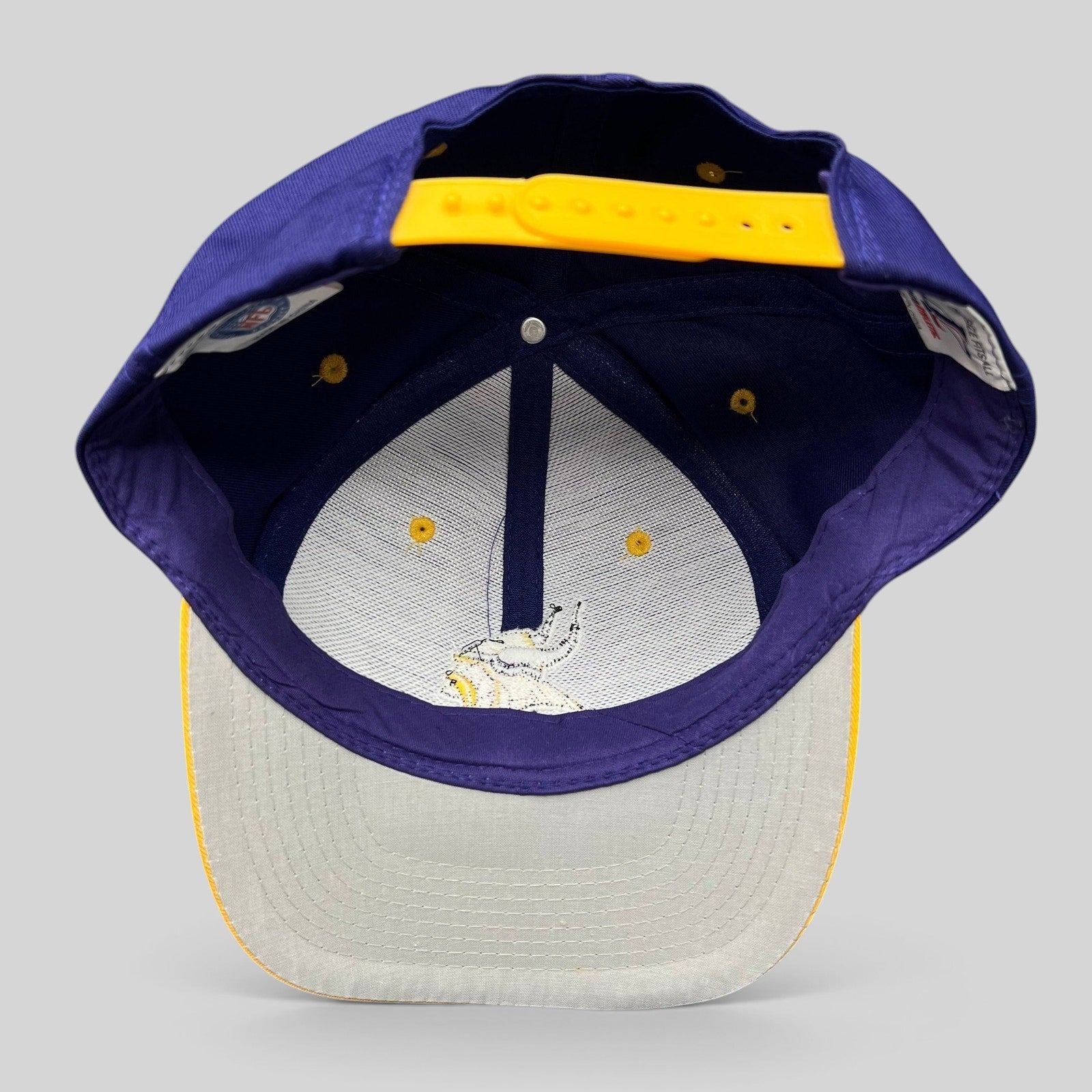 Raree Finds vintage Minnesota Vikings Logo Athletic snapback hat showing the interior crown and yellow plastic strap