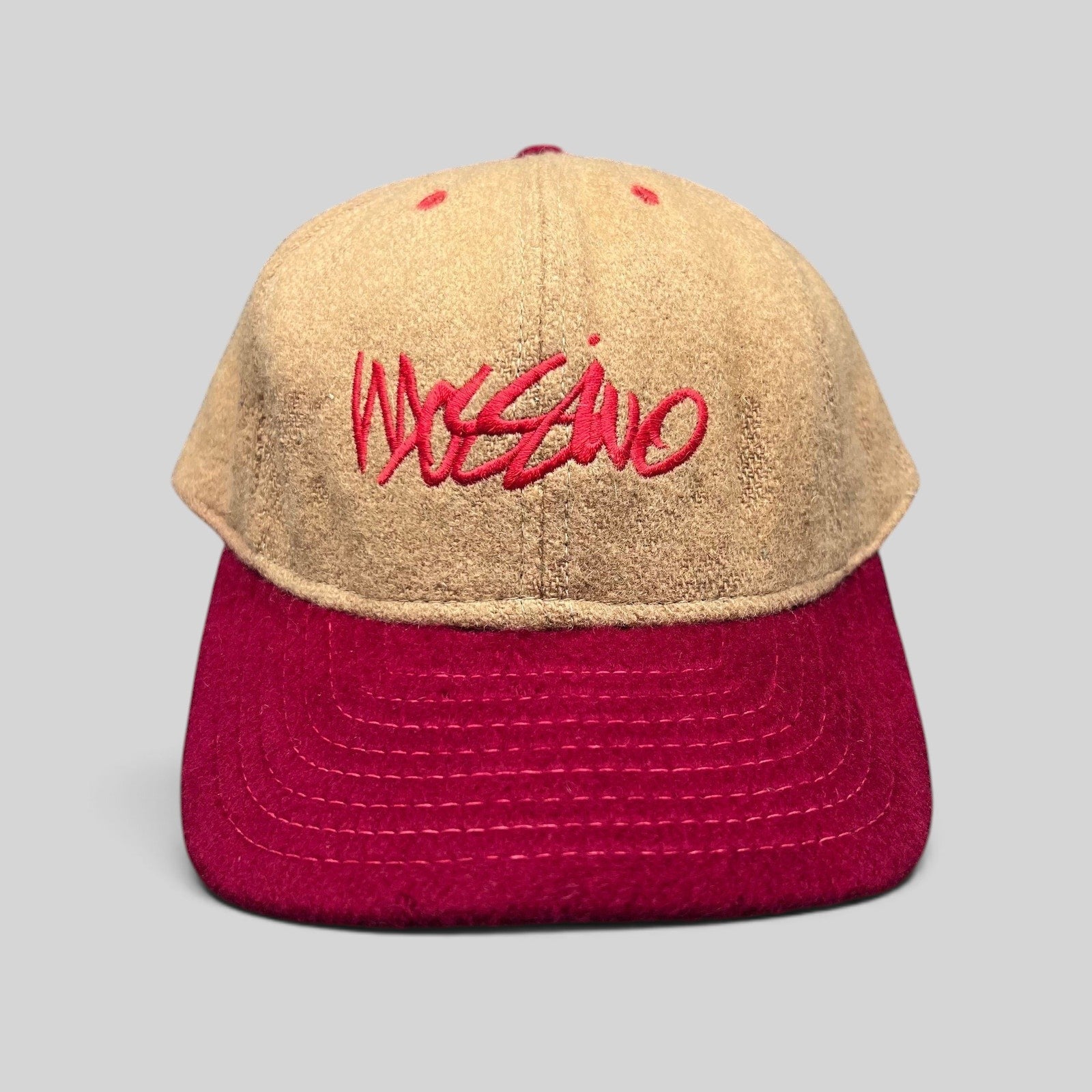 Raree Finds vintage Mossimo wool snapback hat in camel and red with embroidered script logo, front view.