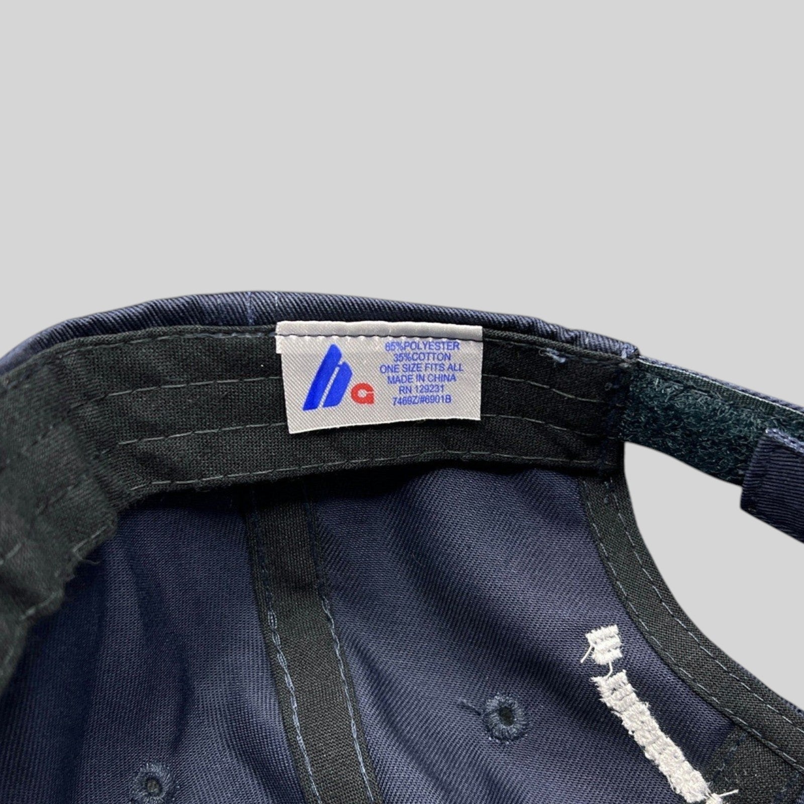 Raree Finds navy cotton-poly blend cap interior showing Sportsman brand tag and adjustable velcro strap