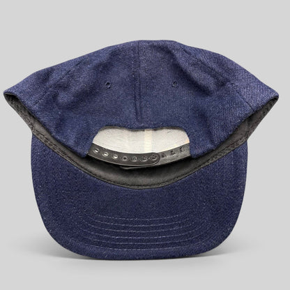 Raree Finds vintage 90s No Fear Gear navy wool-blend snapback hat showing the adjustable black plastic back closure
