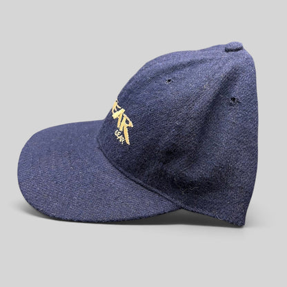 Raree Finds vintage 90s navy wool snapback hat with gold No Fear Gear embroidery and structured six-panel design