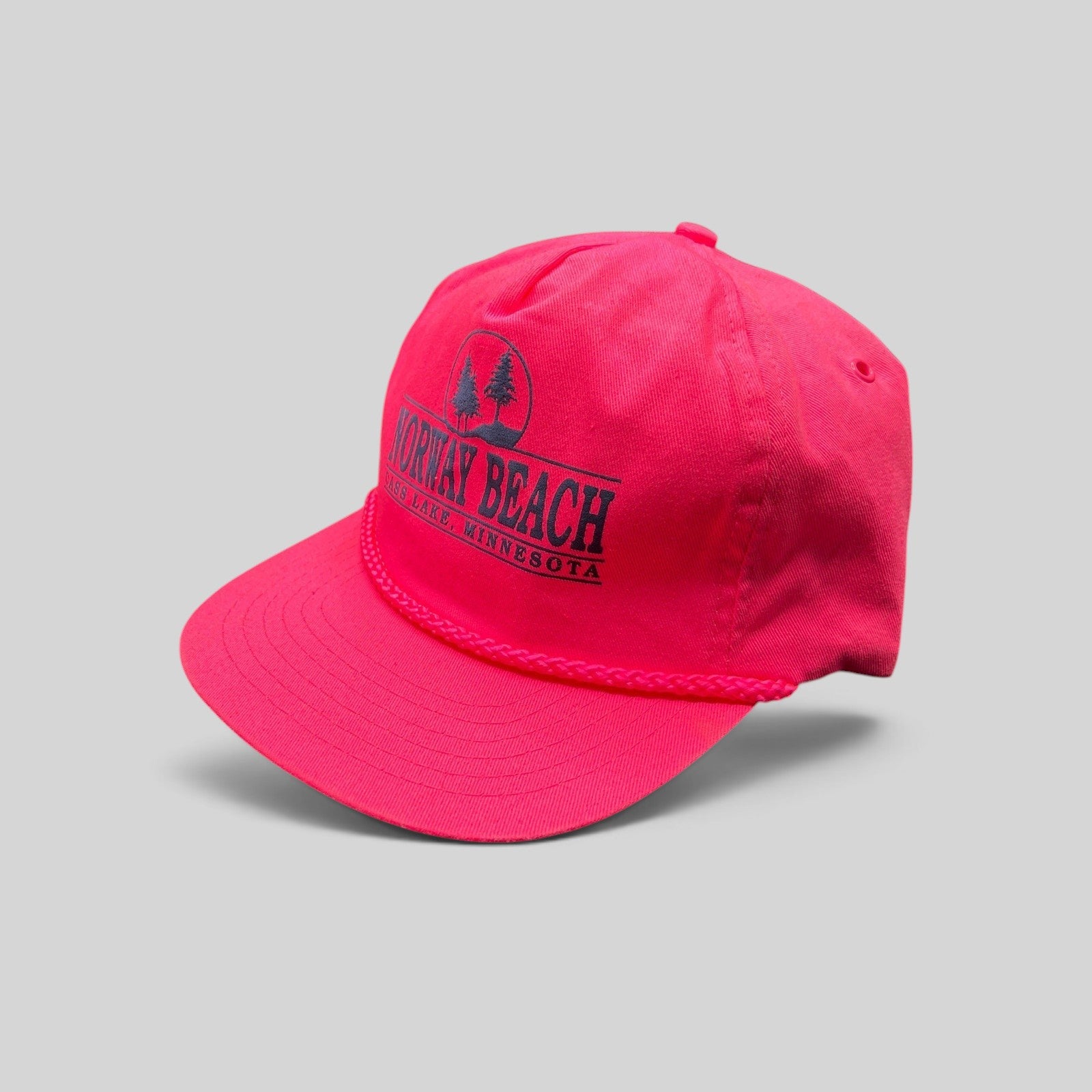 Raree Finds vintage 1980s neon pink snapback hat with navy Norway Beach graphic and decorative front rope detail.