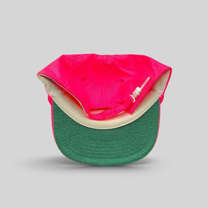 Raree Finds vintage 1980s neon pink snapback hat with a green undervisor and white plastic zipperback closure.