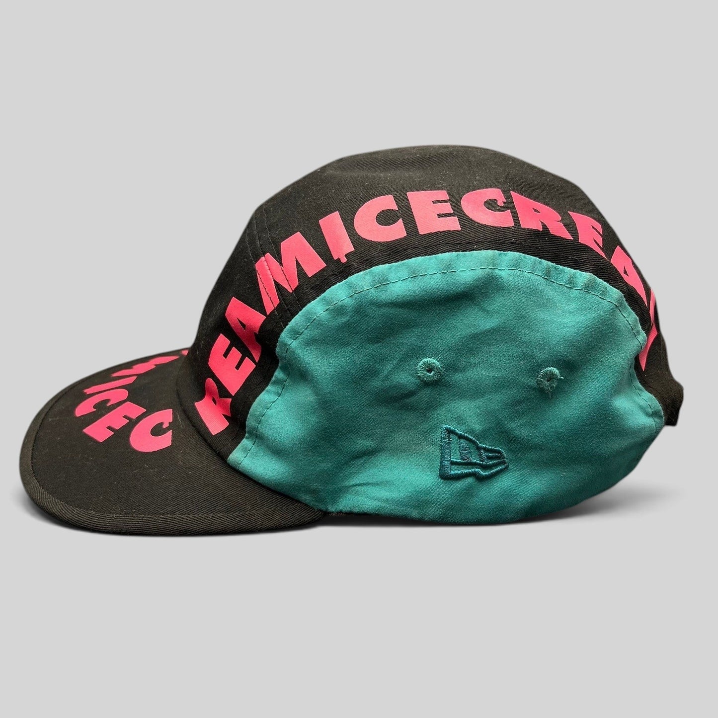 Raree Finds New Era Ice Cream America strapback hat in black with vibrant pink graphic text and teal side panels.