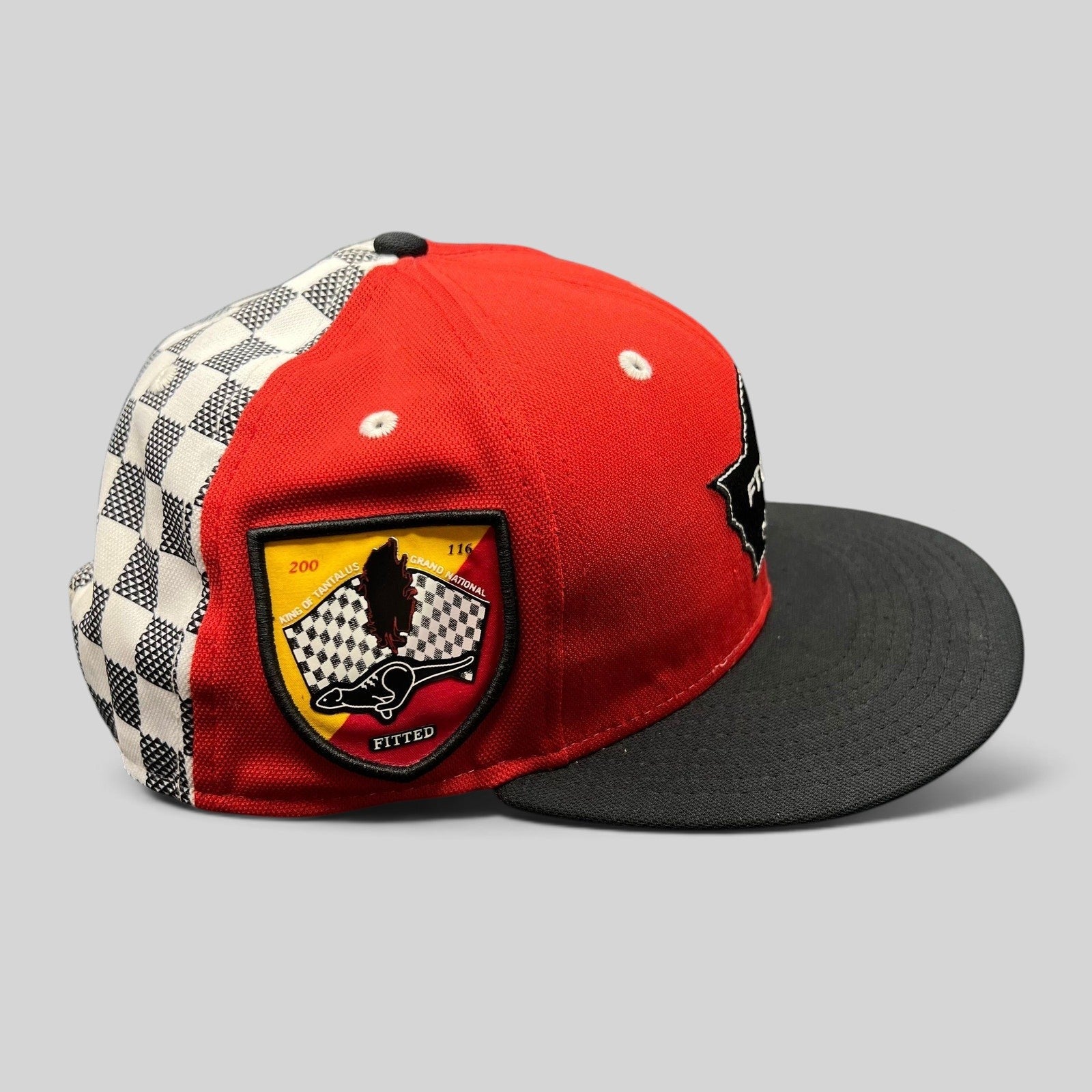Raree Finds New Era King of Tantalus snapback hat in red and black with a checkered side panel and event patch.
