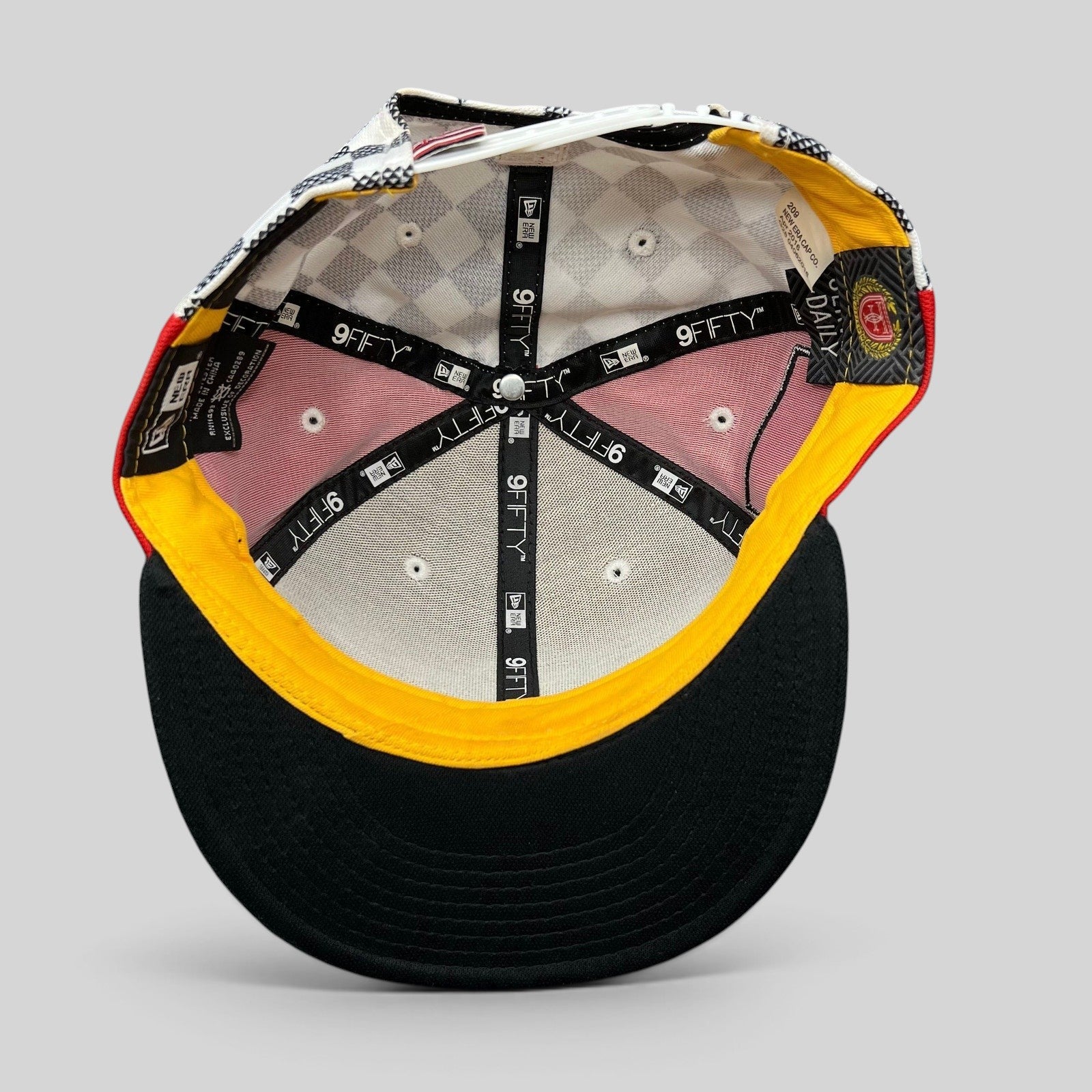 Interior view of a Raree Finds New Era King of Tantalus snapback hat showing branded taping and patterned lining