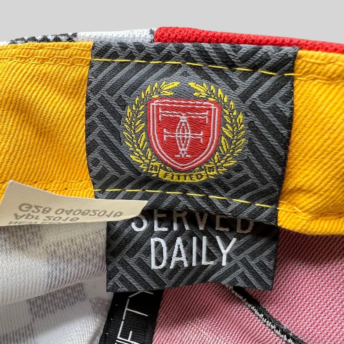 Raree Finds New Era snapback interior label featuring a red and yellow crest logo with Served Daily embroidery