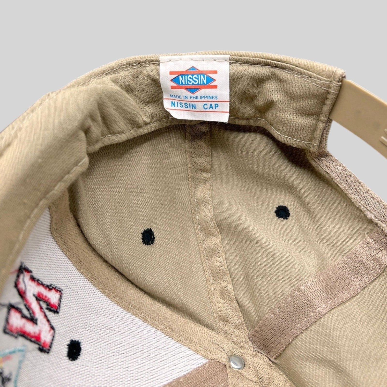 Raree Finds vintage 1996 Tostitos Fiesta Bowl snapback hat interior showing the Nissin Cap brand label and tan lining.