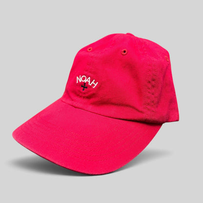Raree Finds red cotton strapback hat by NOAH featuring white embroidered cross logo and unstructured design