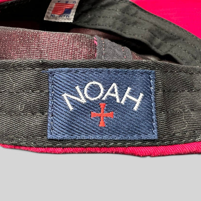 Raree Finds NOAH red cotton strapback hat featuring the brand's signature blue embroidered cross logo tag