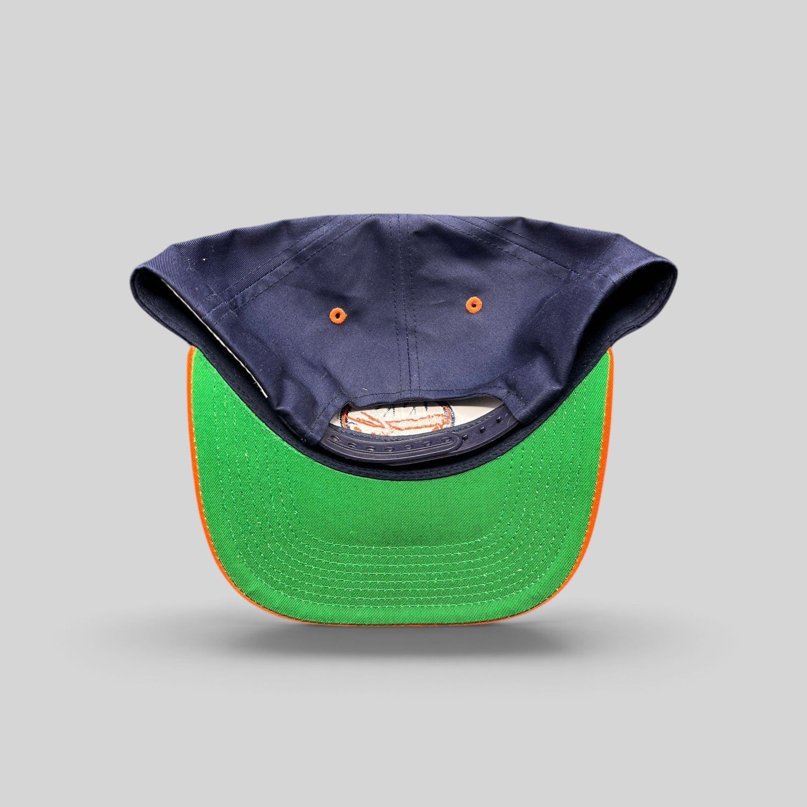 Raree Finds vintage New York Islanders snapback hat showing the navy crown, orange brim, and classic green undervisor.