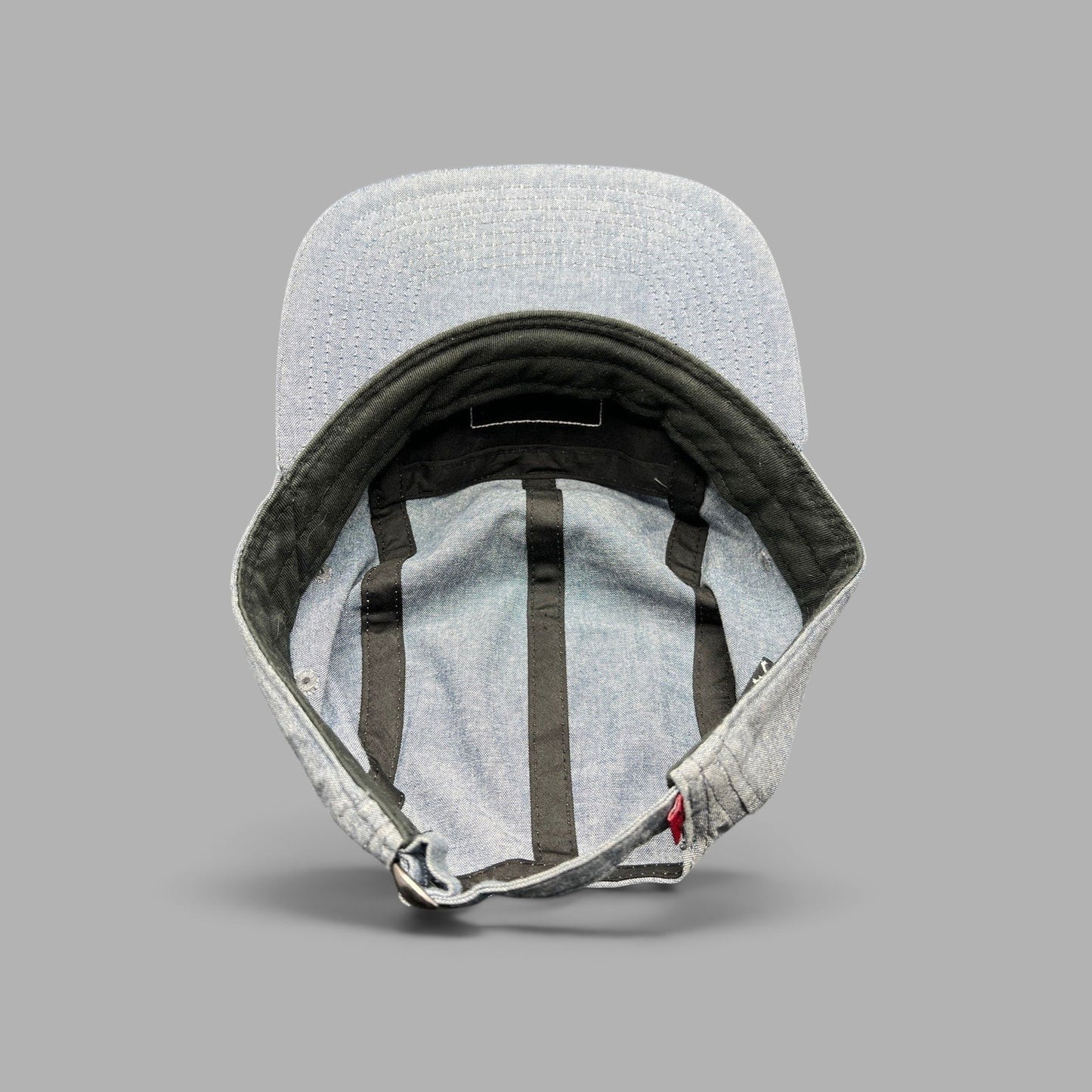 Raree Finds Oakley light denim chambray 5-panel camp cap showing interior construction and adjustable metal buckle