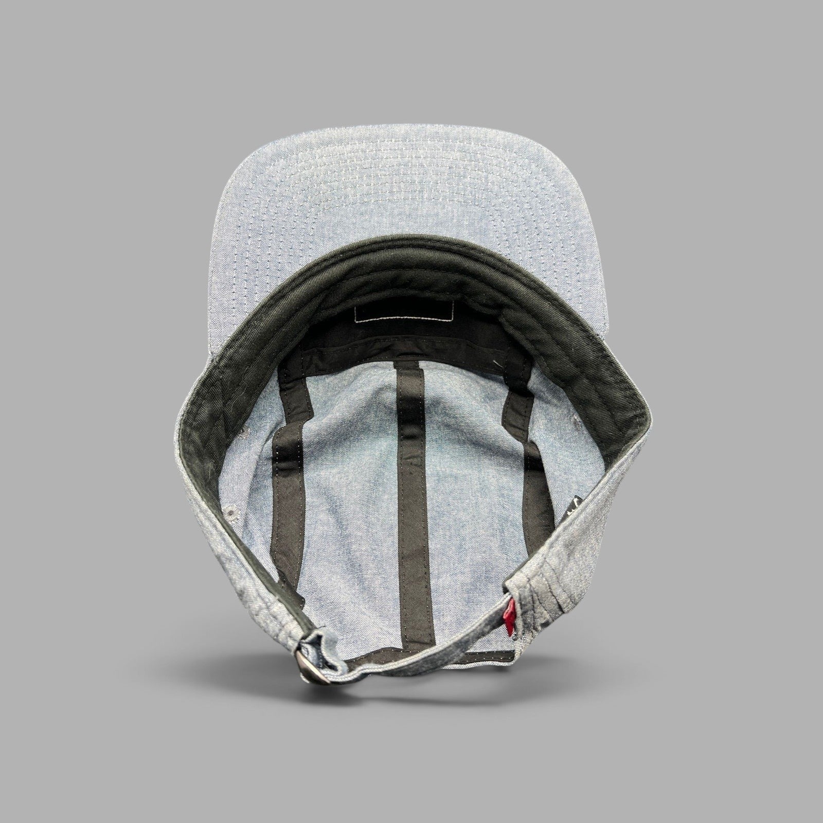 Raree Finds Oakley light denim chambray 5-panel camp cap showing interior construction and adjustable metal buckle