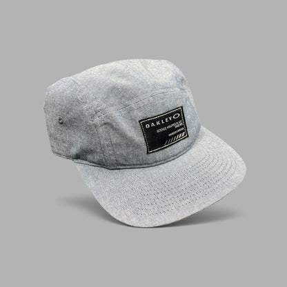 Raree Finds Oakley 5-panel camp cap in light denim chambray with a black Science Wrapped in Art front patch