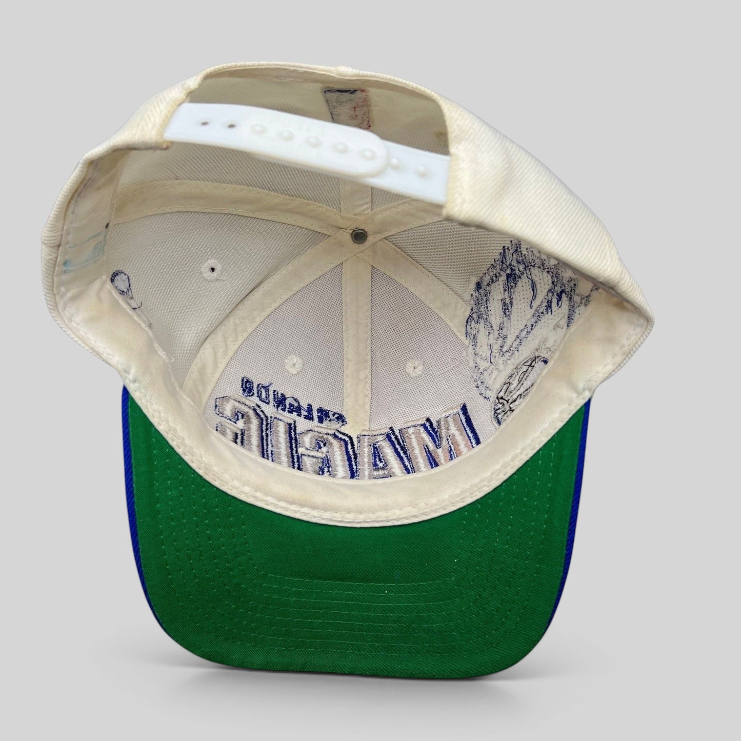 Raree Finds vintage Sports Specialties Orlando Magic snapback hat interior showing green undervisor and snap closure
