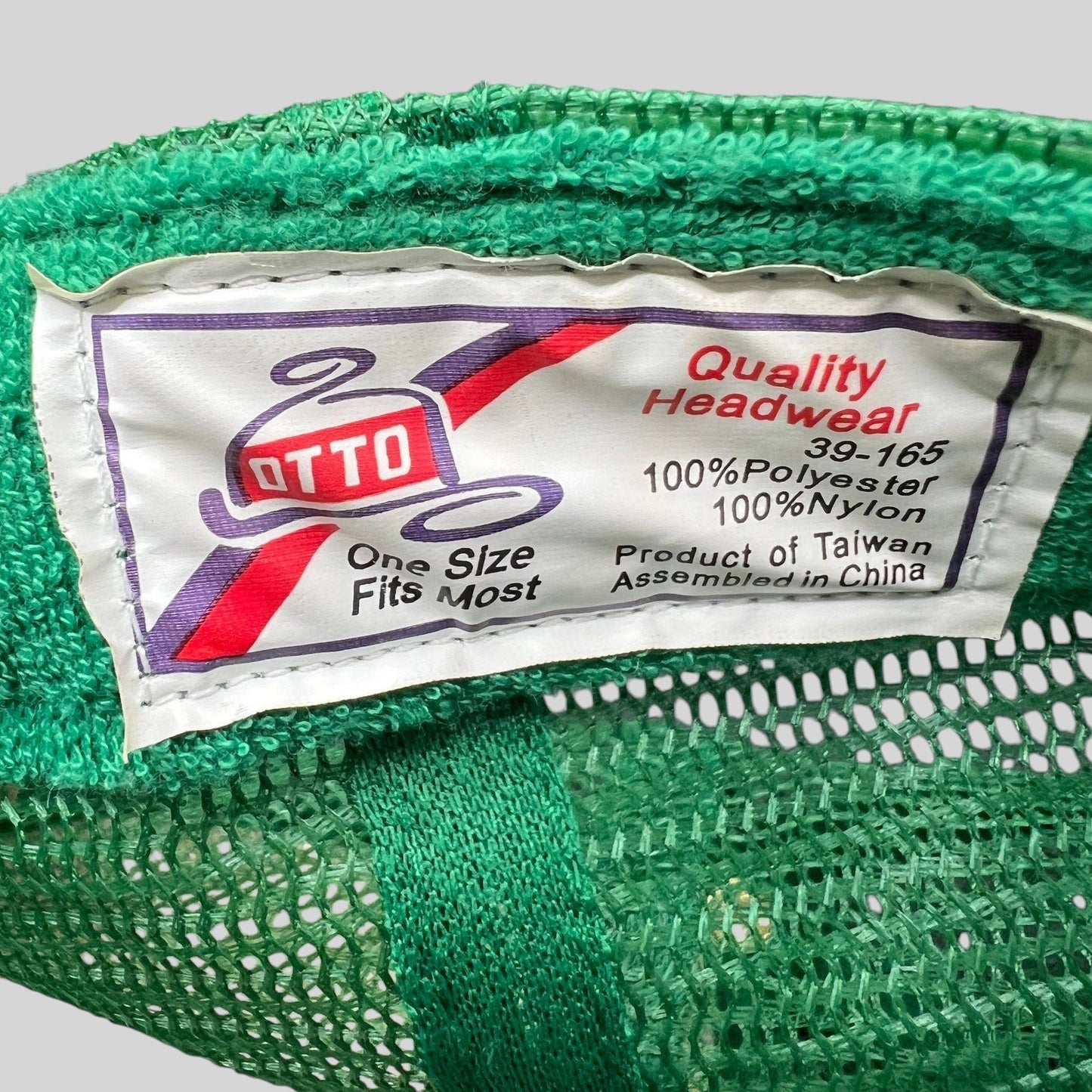 Raree Finds vintage Otto Cap trucker hat interior tag showing polyester and nylon material details