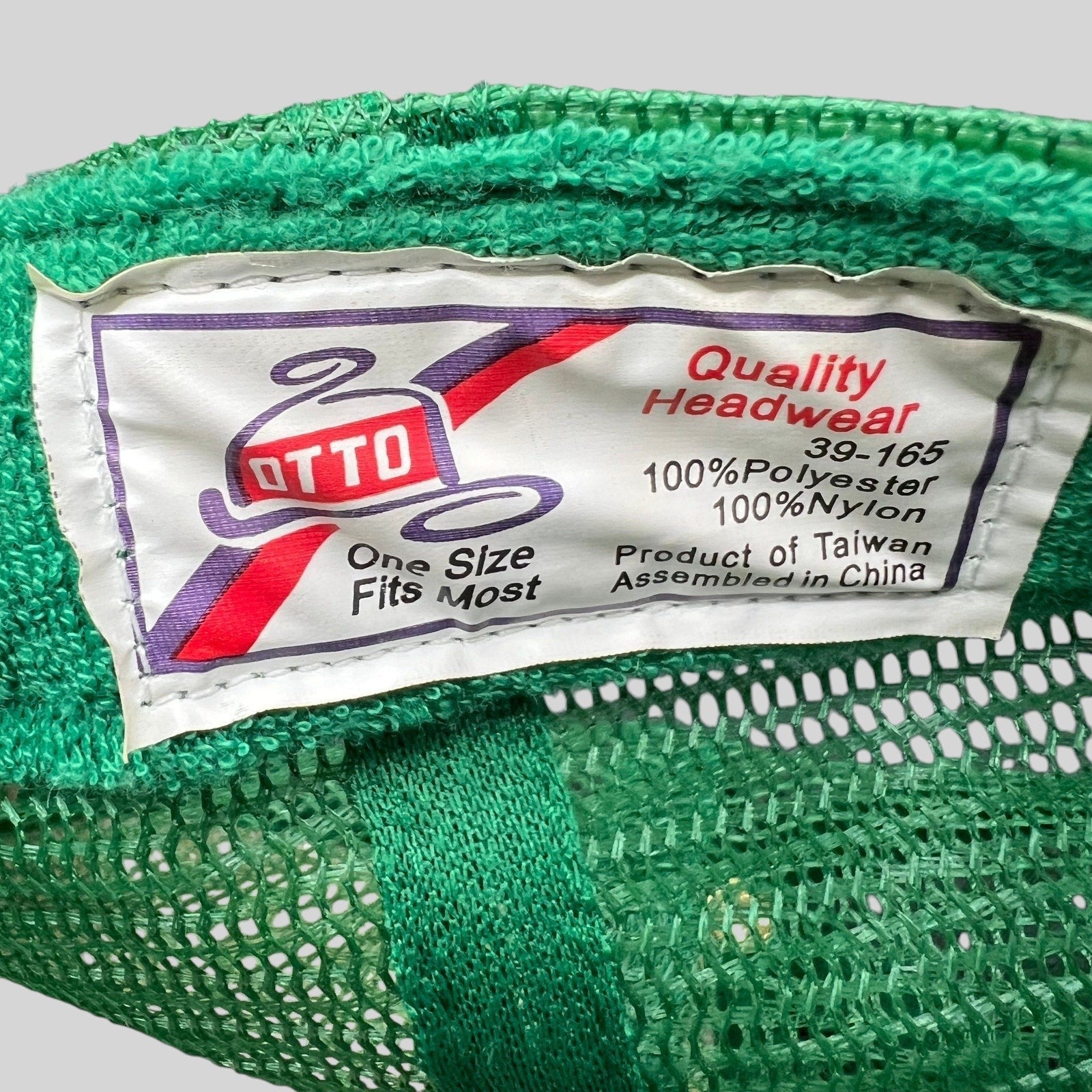 Raree Finds vintage Otto Cap trucker hat interior tag showing polyester and nylon material details
