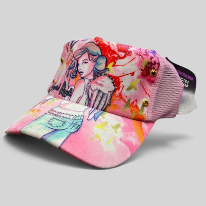 Raree Finds Crystal Rock by Christian Audigier pink trucker hat with angel graphic, rhinestones, and metallic studs.