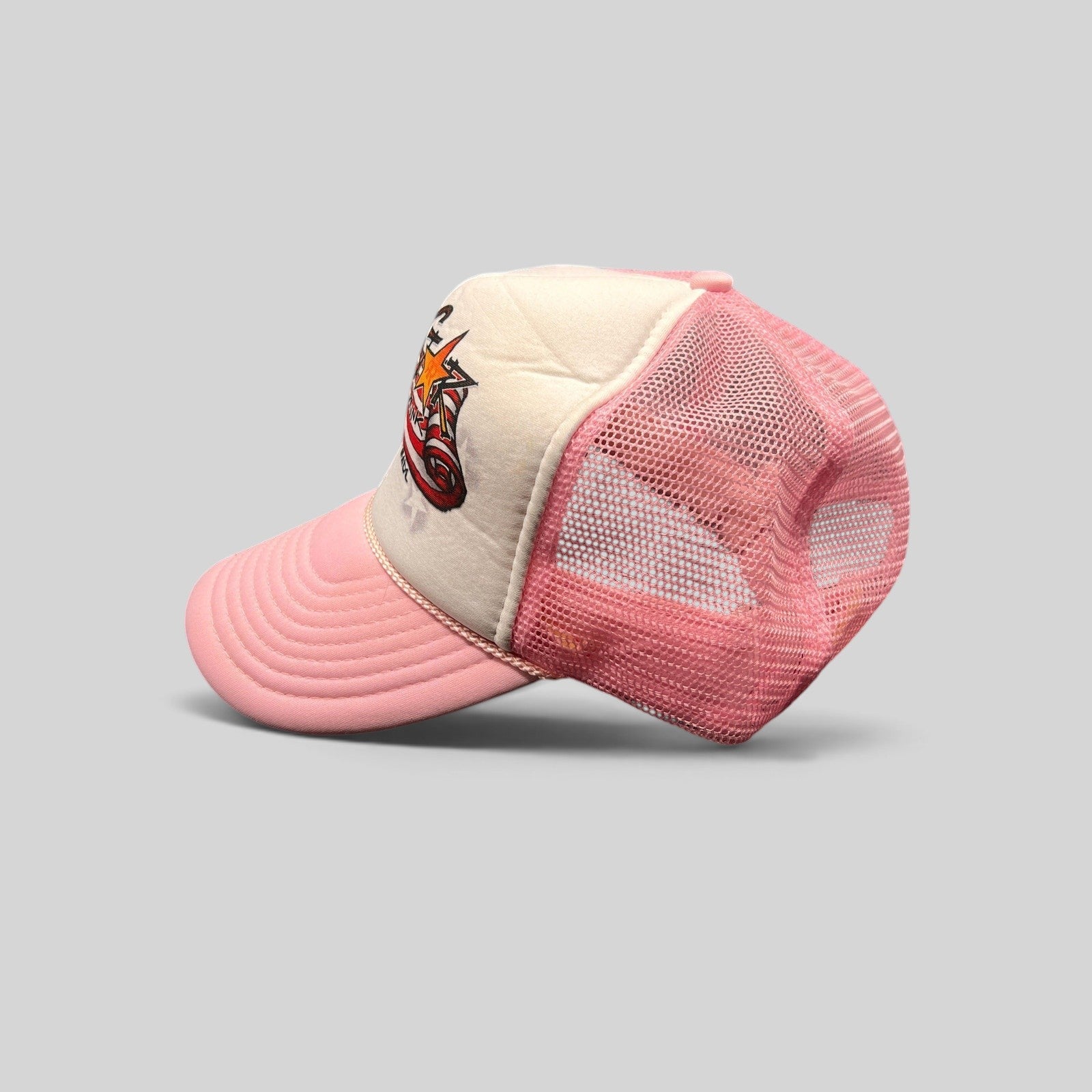 Raree Finds vintage Rockstar Energy Drink trucker hat with white foam front, pink mesh back, and American flag logo.