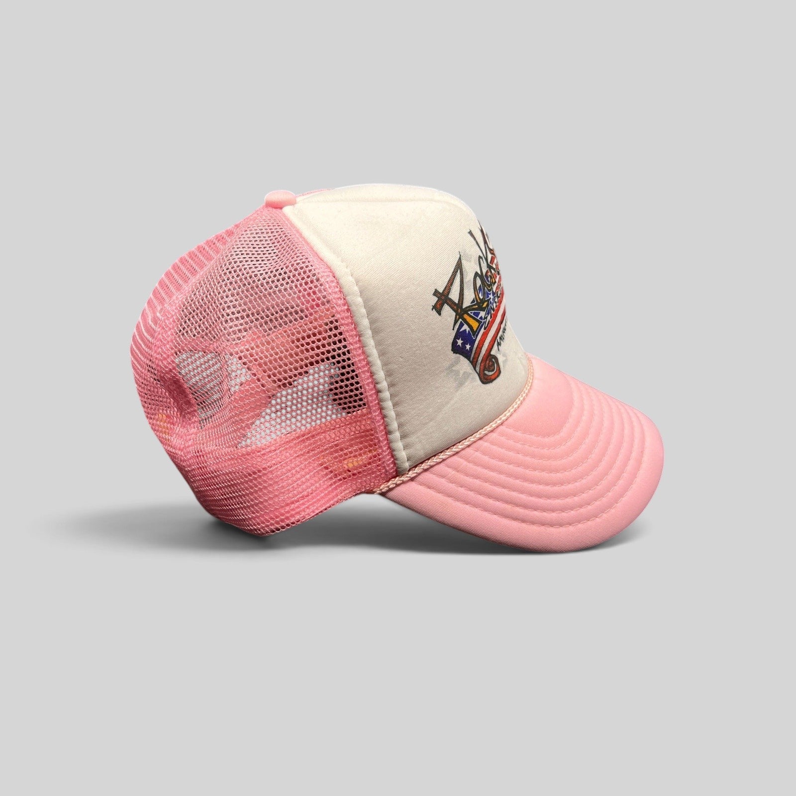Raree Finds vintage Rockstar Energy Drink trucker hat with white foam front, pink mesh back, and American flag logo.