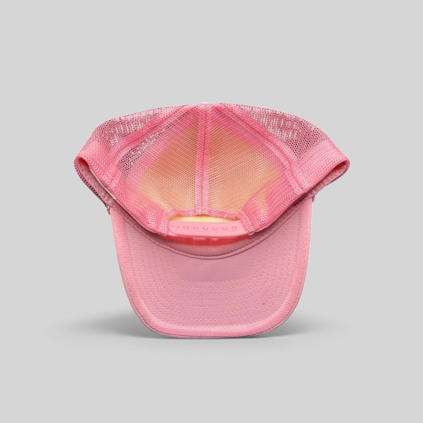 Raree Finds vintage Rockstar Energy Drink trucker hat showing the interior pink mesh lining and adjustable snapback