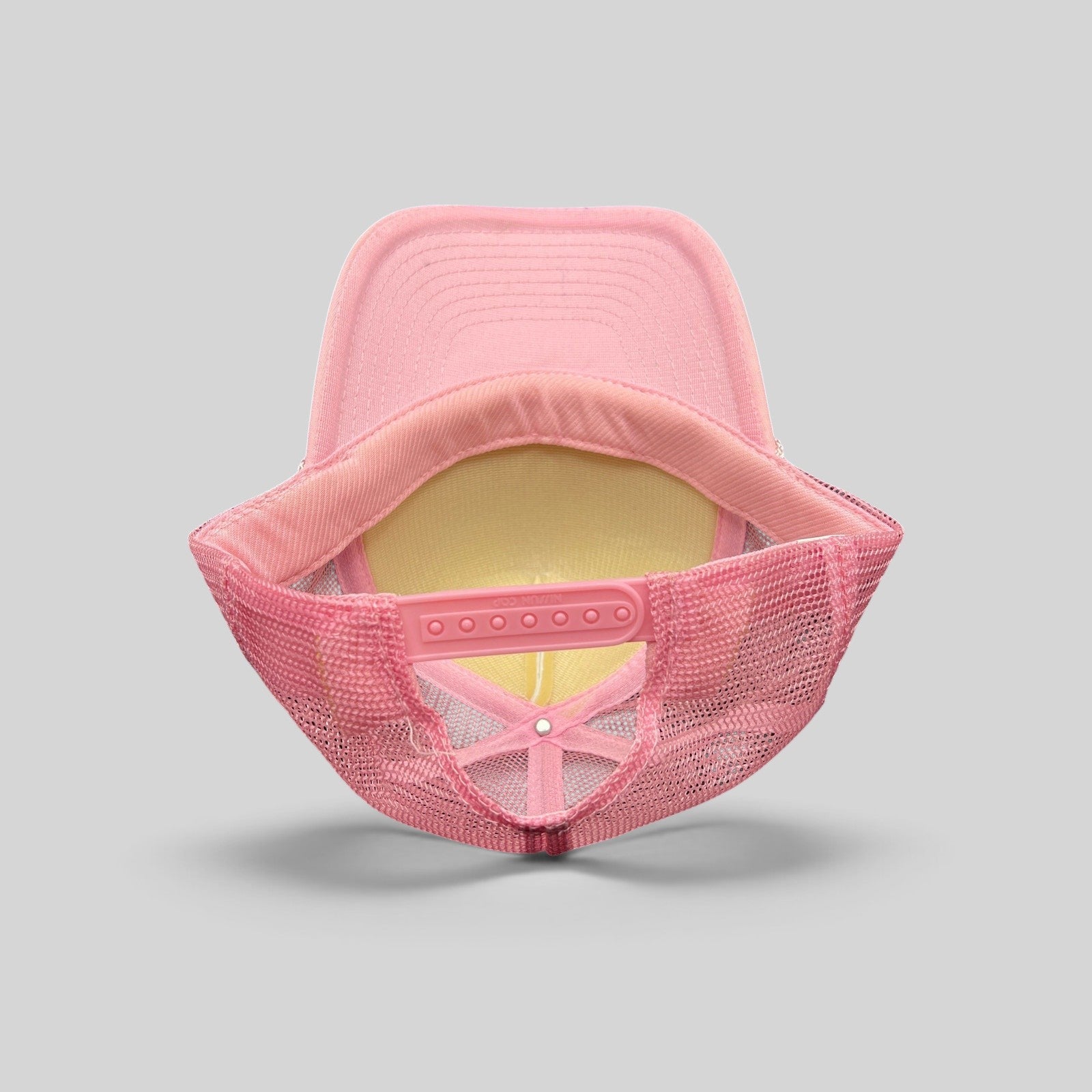 Raree Finds vintage Rockstar Energy Drink trucker hat showing the interior pink mesh and adjustable snapback closure.