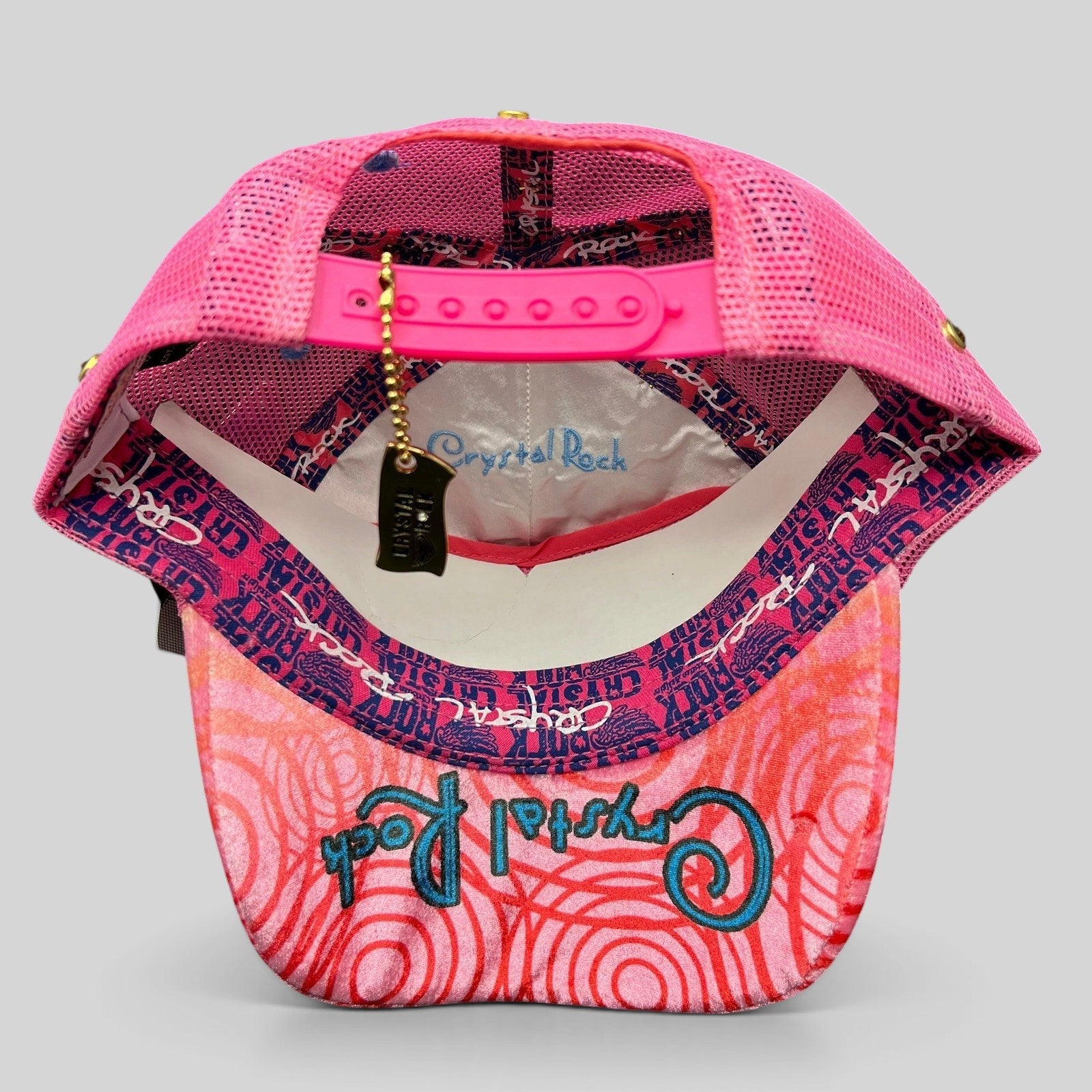 Raree Finds Crystal Rock by Christian Audigier pink trucker hat with branded tag and graphic print underside of bill