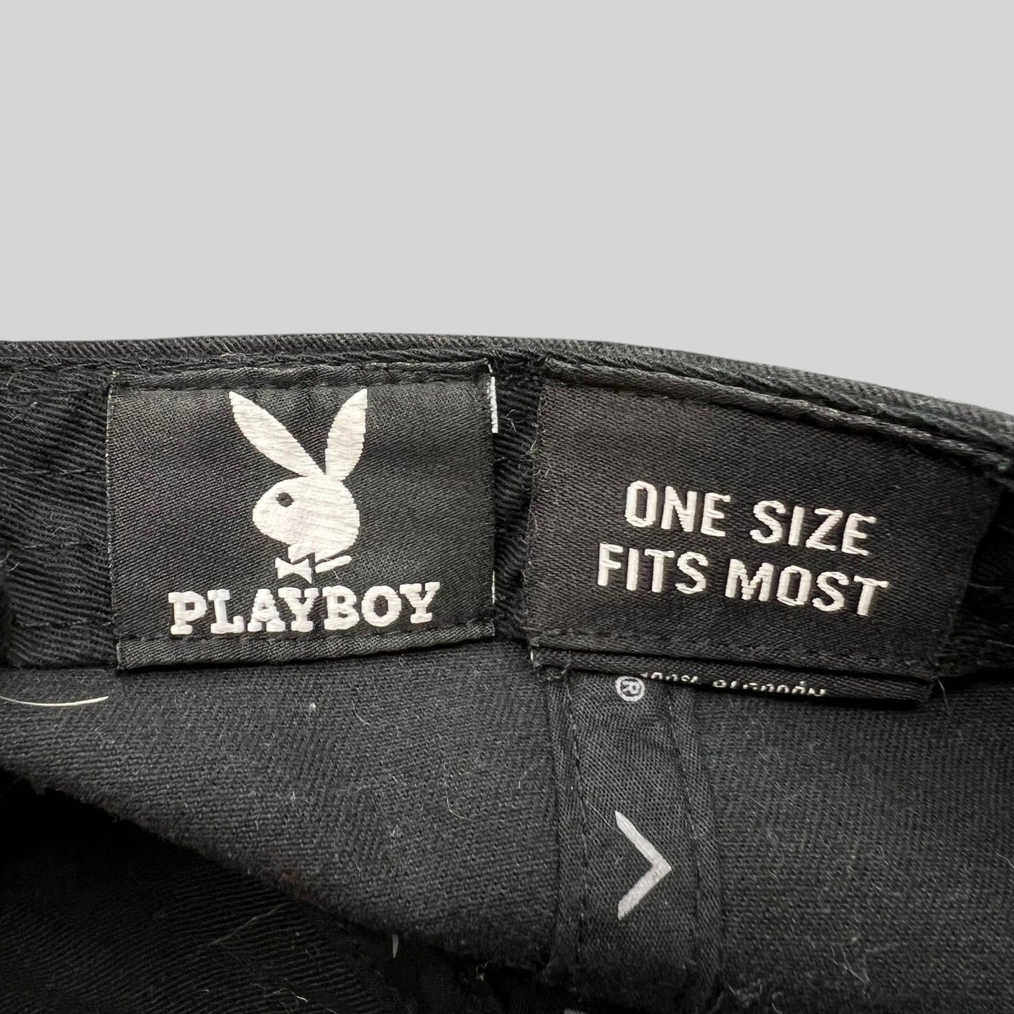 Raree Finds black Playboy strapback hat interior label with bunny logo and one size fits most text