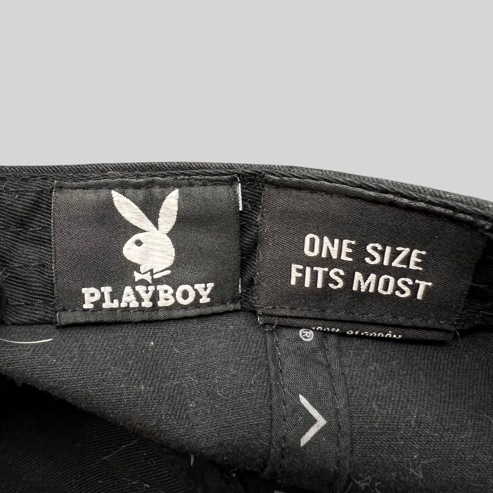 Raree Finds black Playboy strapback hat interior label with bunny logo and one size fits most text