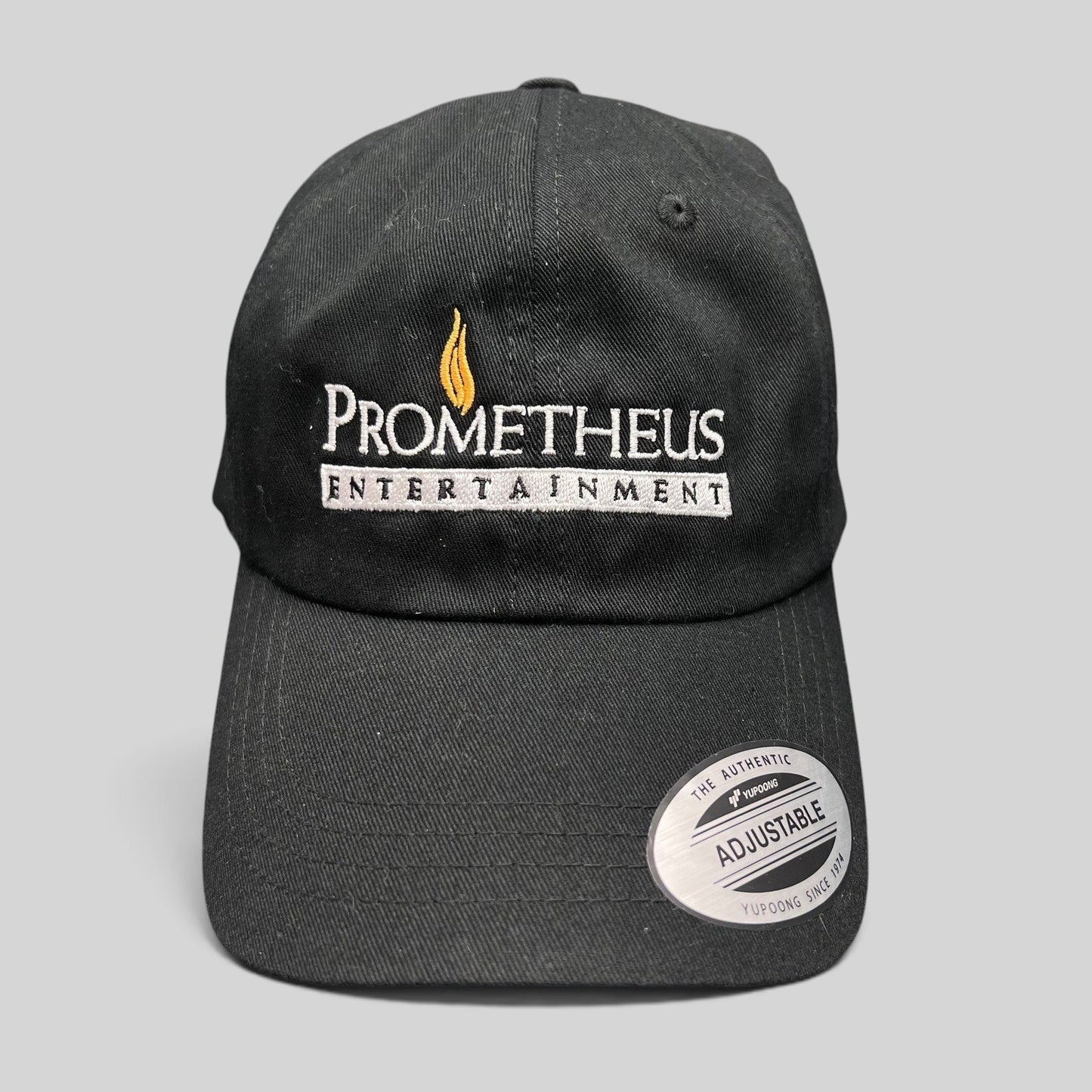 Raree Finds black Yupoong strapback hat with embroidered Prometheus Entertainment logo and original brim sticker