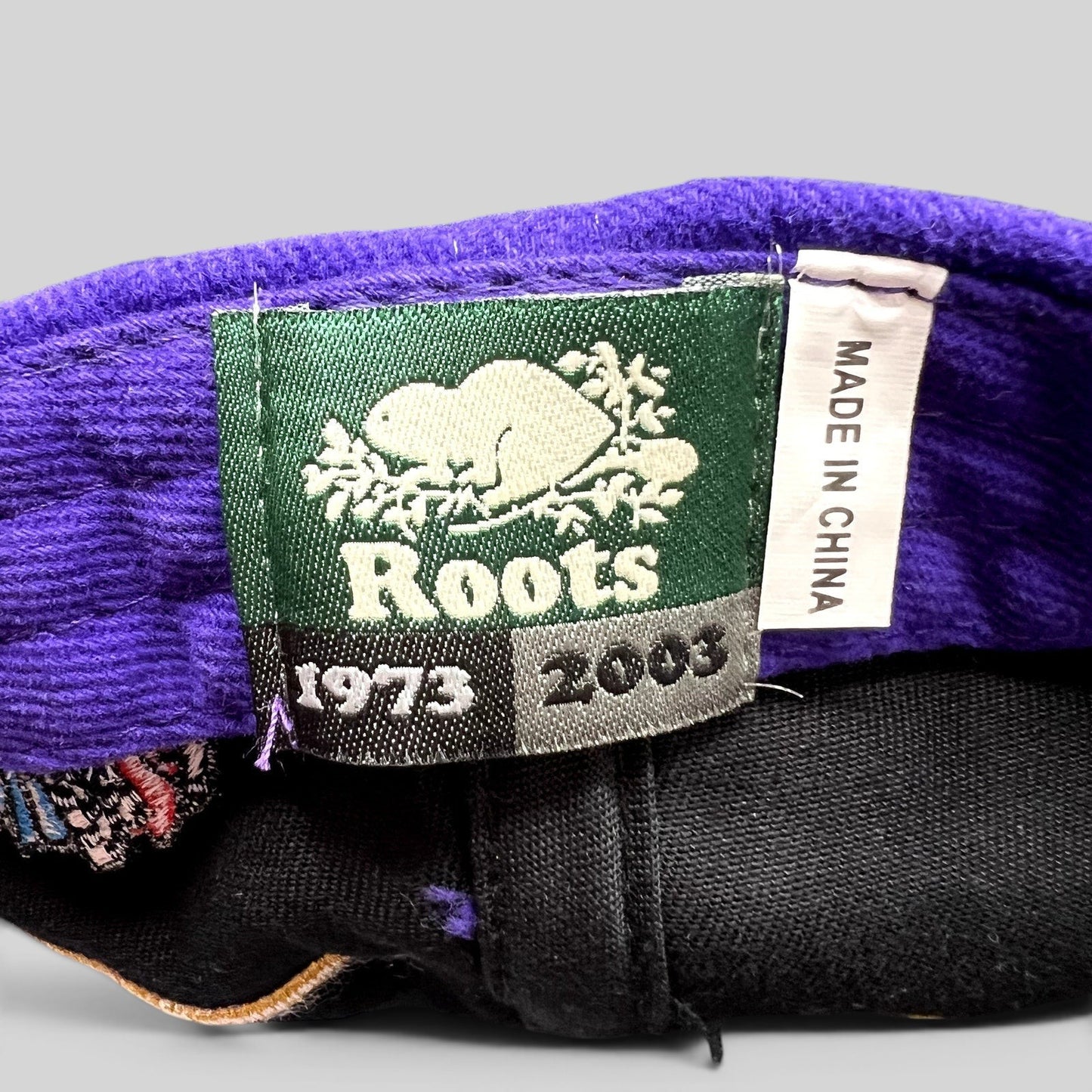 Raree Finds vintage 2003 Roots brand label inside a purple and black Crown Royal promotional hat