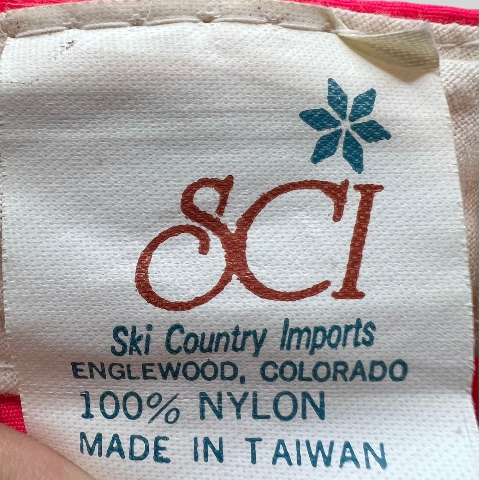 Raree Finds vintage 80s SCI Ski Country Imports nylon hat care label with blue logo and text on white fabric