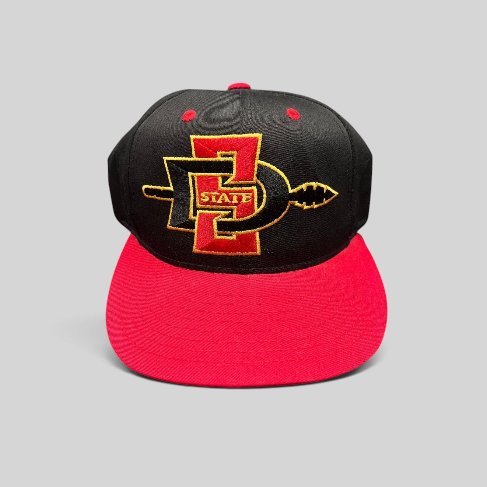 Raree Finds vintage San Diego State Aztecs snapback hat in black and red cotton with gold embroidered SDSU spear logo.