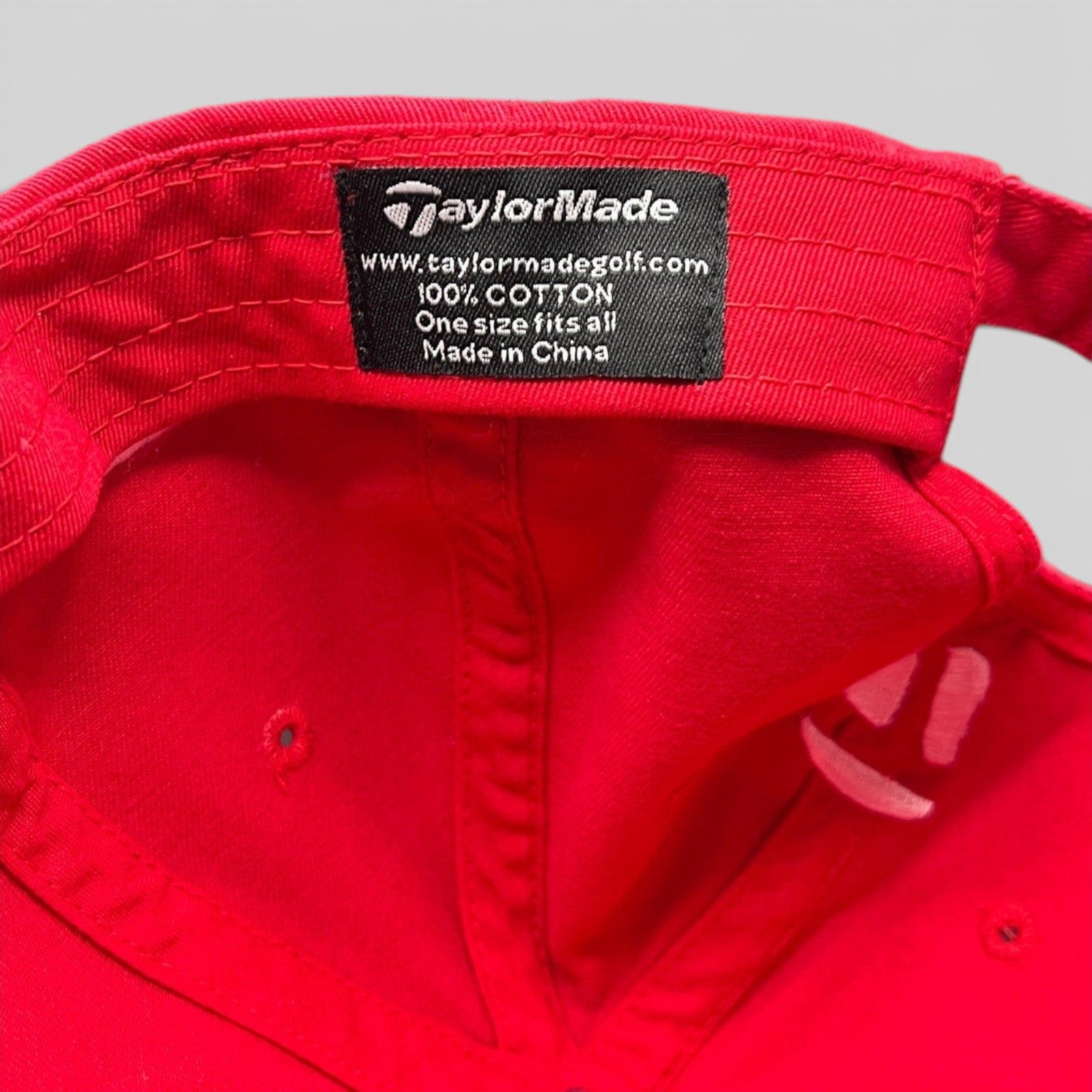 Raree Finds TaylorMade red cotton golf hat interior label showing brand logo and material details