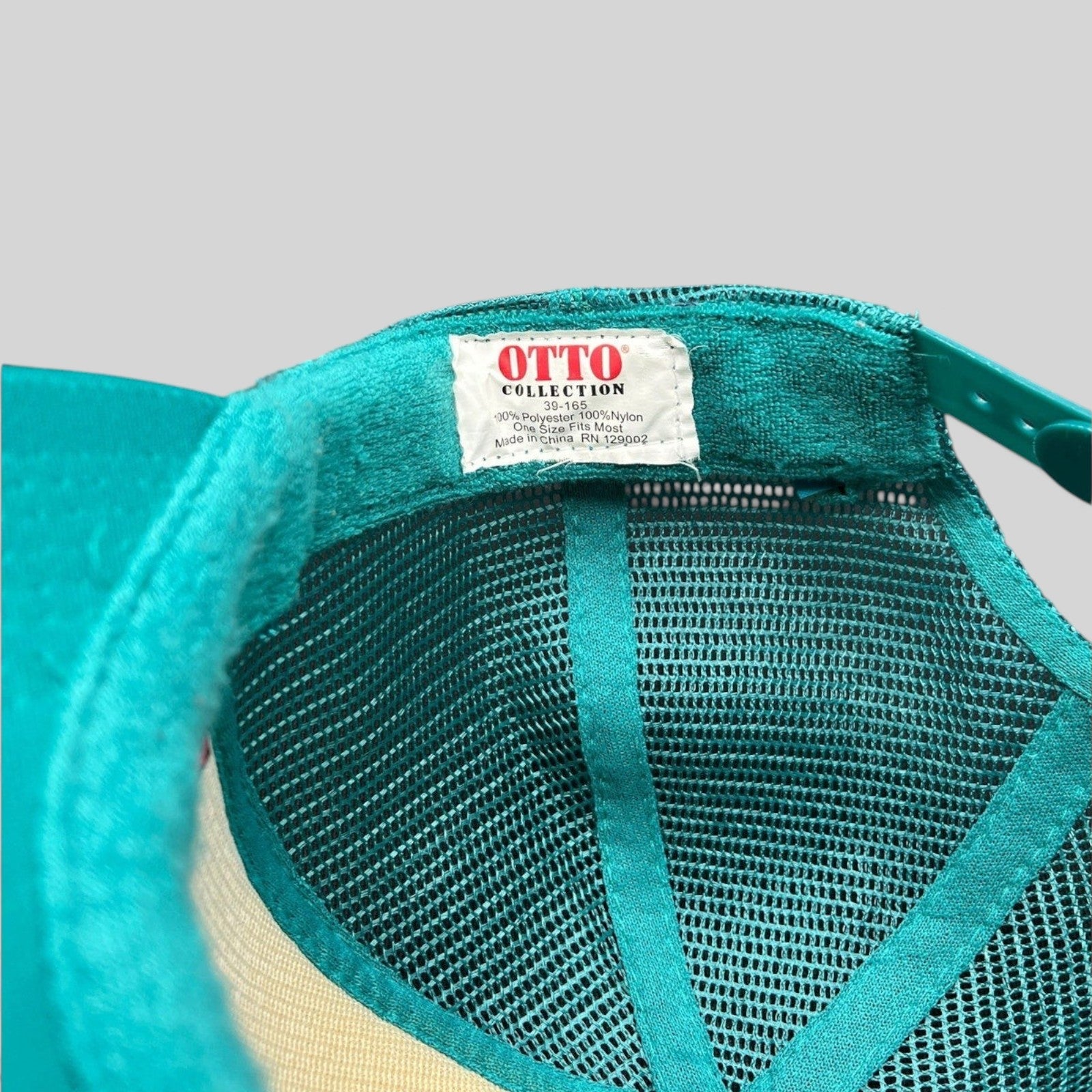 Raree Finds teal mesh trucker hat interior showing Otto Collection label and adjustable snapback closure