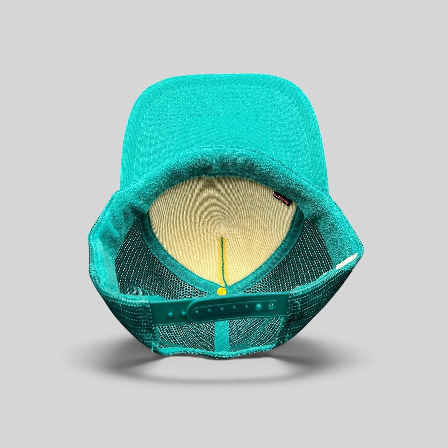 Raree Finds teal Volcom Hawaii trucker hat showing the interior foam front panel, mesh back, and snapback closure.