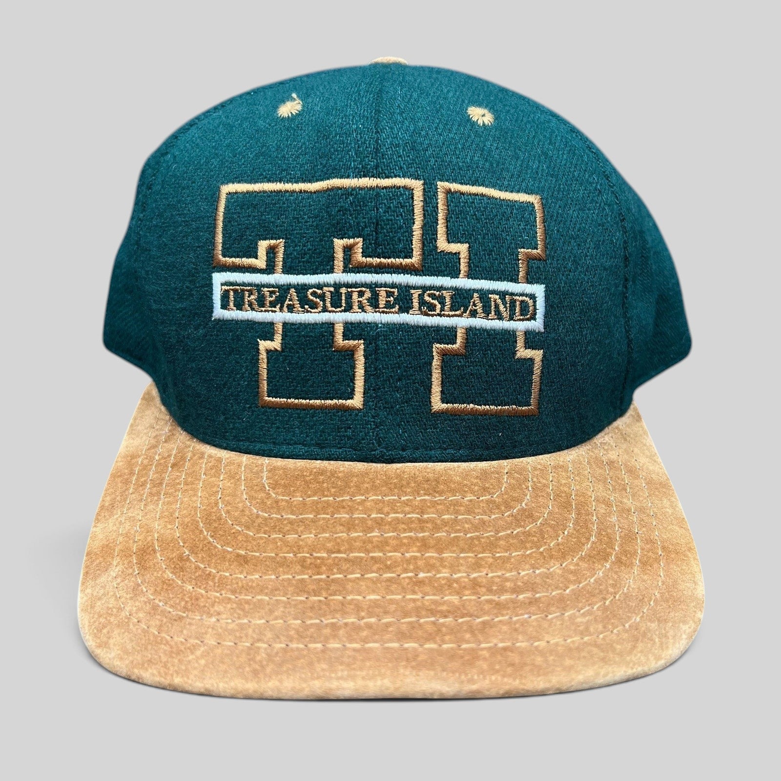 Raree Finds vintage Treasure Island Las Vegas snapback hat with a green wool crown and tan suede brim.
