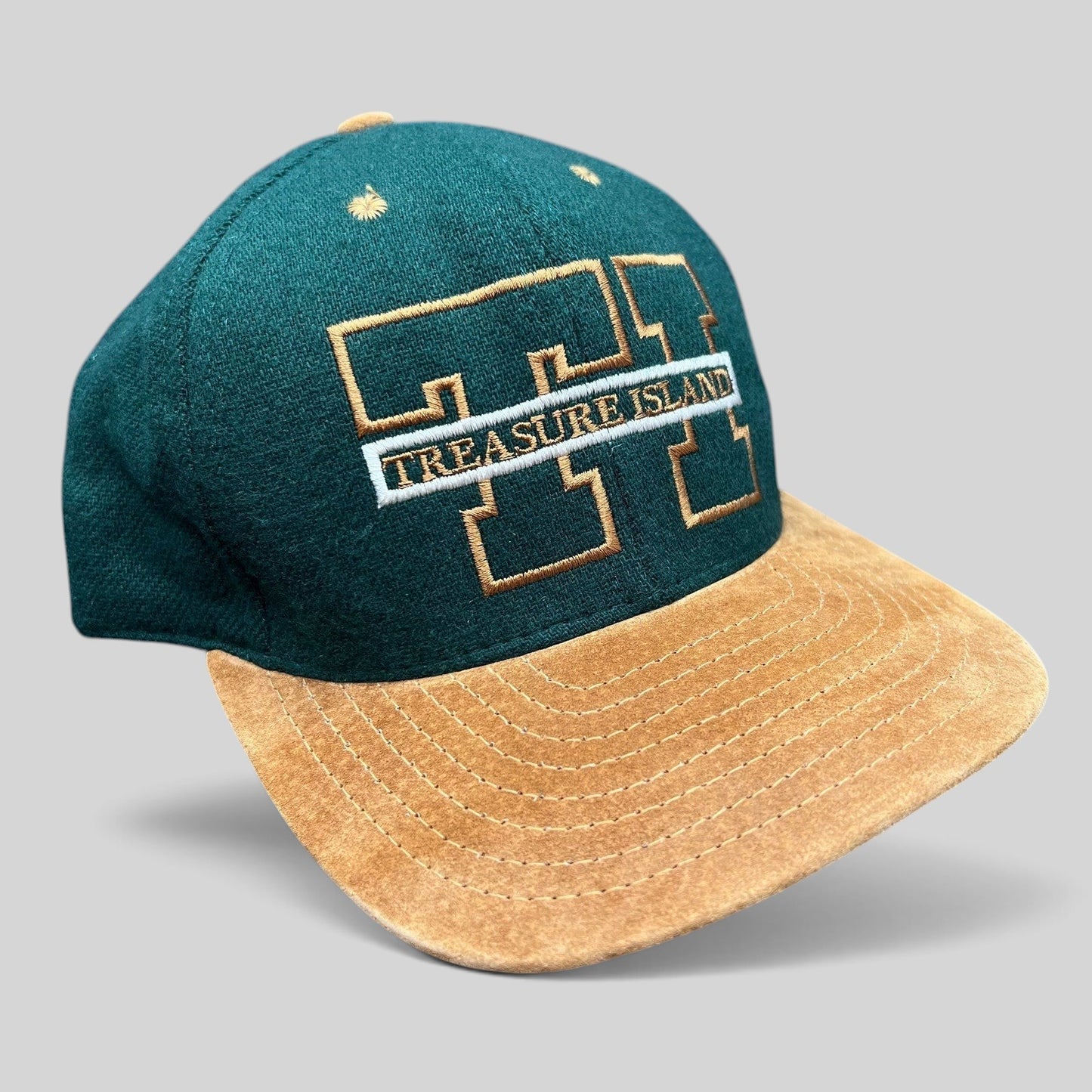 Raree Finds vintage Treasure Island Las Vegas snapback hat with a green wool crown and tan suede brim.