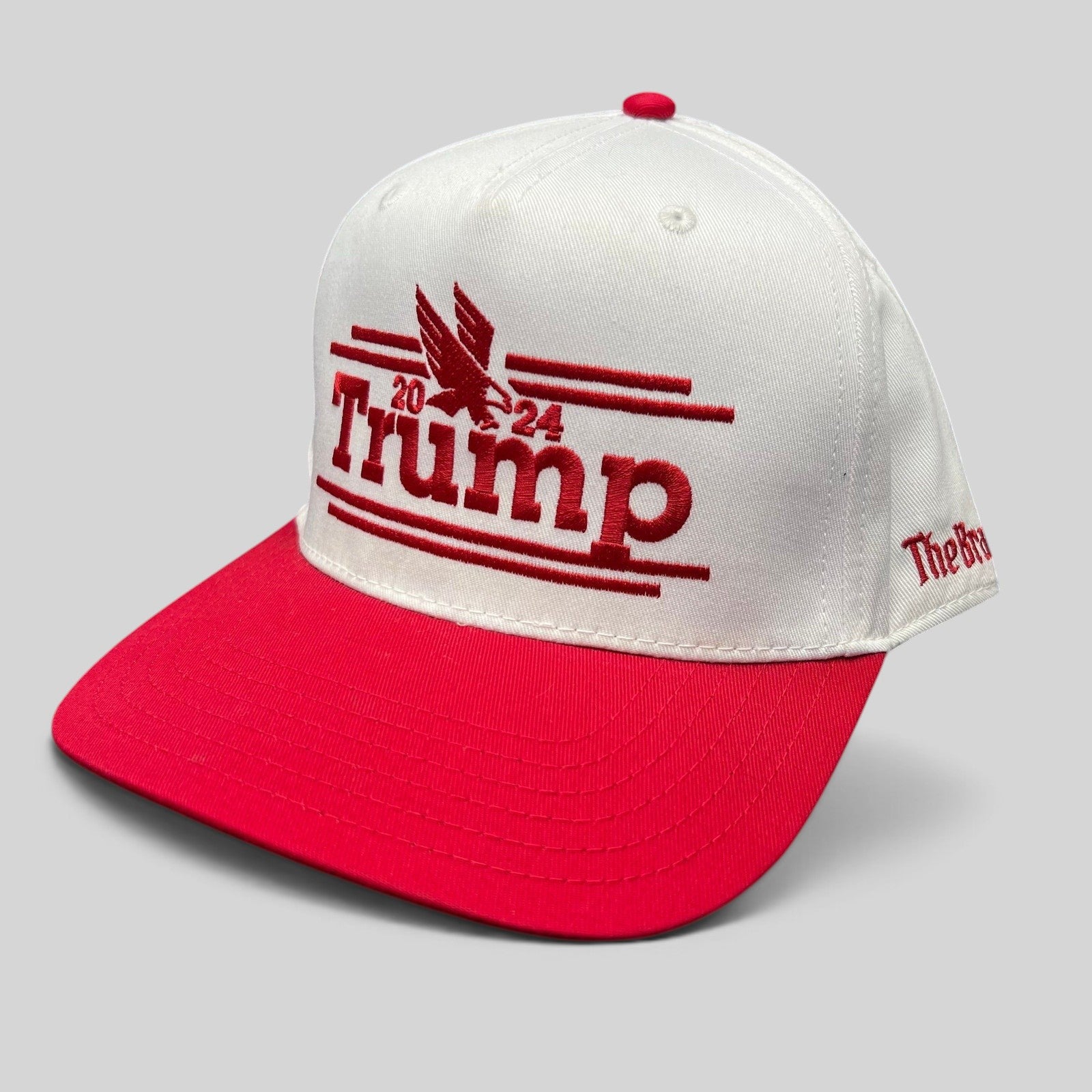 Raree Finds Trump 2024 campaign snapback hat with a white crown, red flat brim, and red embroidered eagle logo.