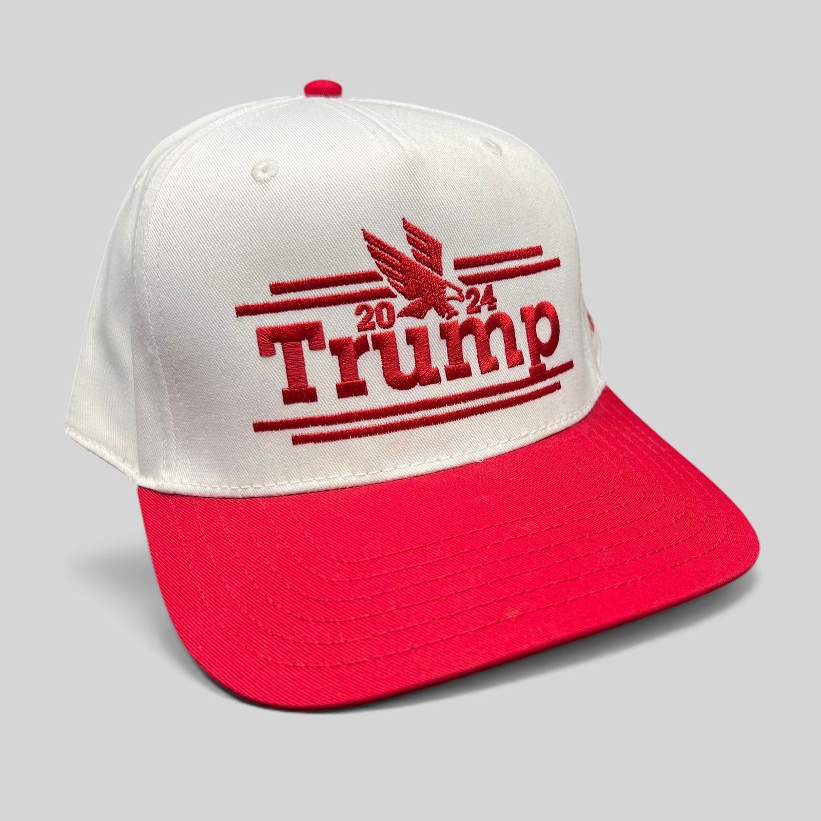 Raree Finds Trump 2024 campaign snapback hat with a white crown, red flat brim, and red embroidered eagle logo.
