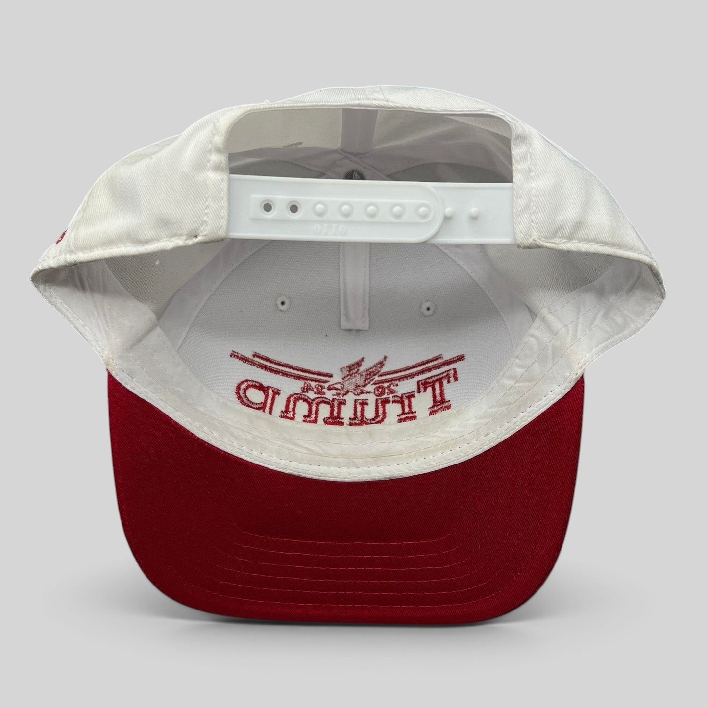 Raree Finds Trump 2024 snapback hat interior view showing white crown, red bill, and adjustable plastic closure