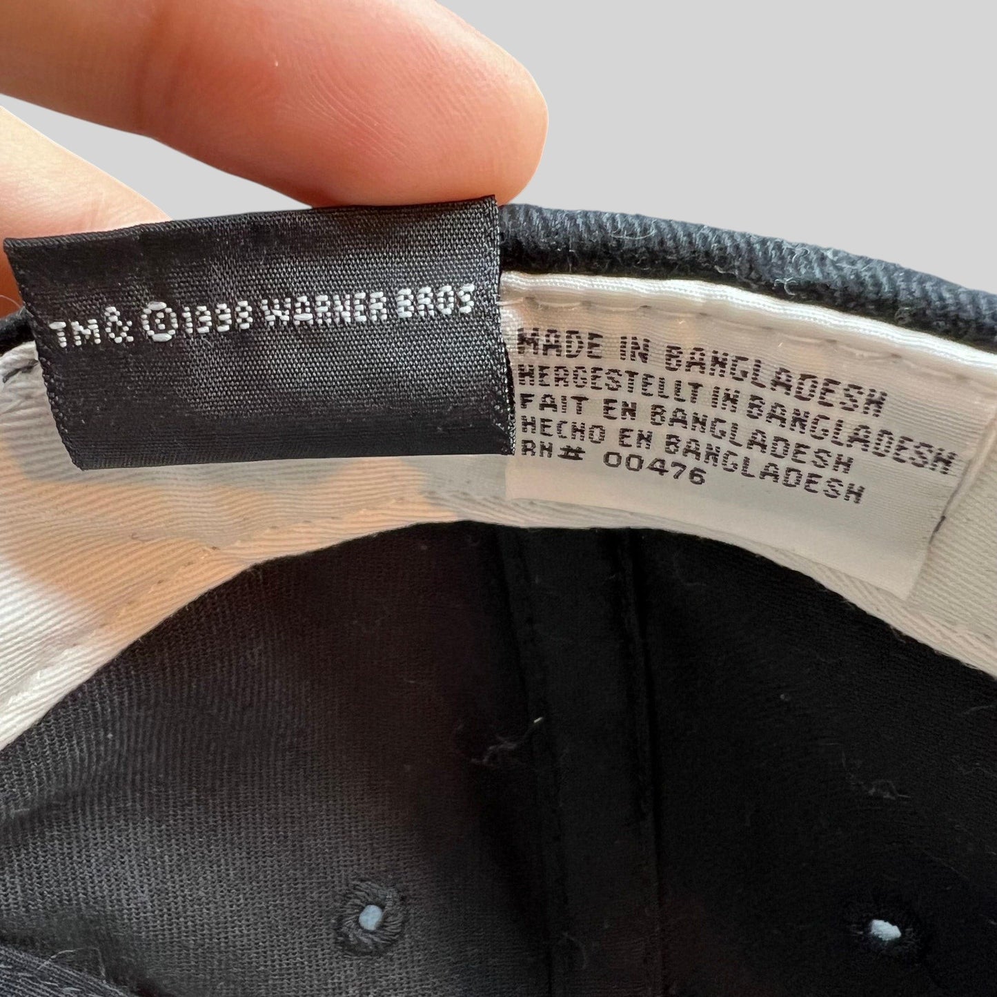 Raree Finds vintage 1998 Warner Bros Tweety Bird hat interior tag showing manufacturing details and copyright
