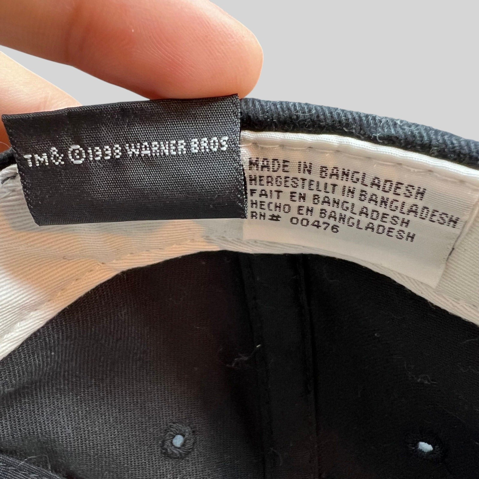 Raree Finds vintage 1998 Warner Bros Tweety Bird hat interior tag showing manufacturing details and copyright