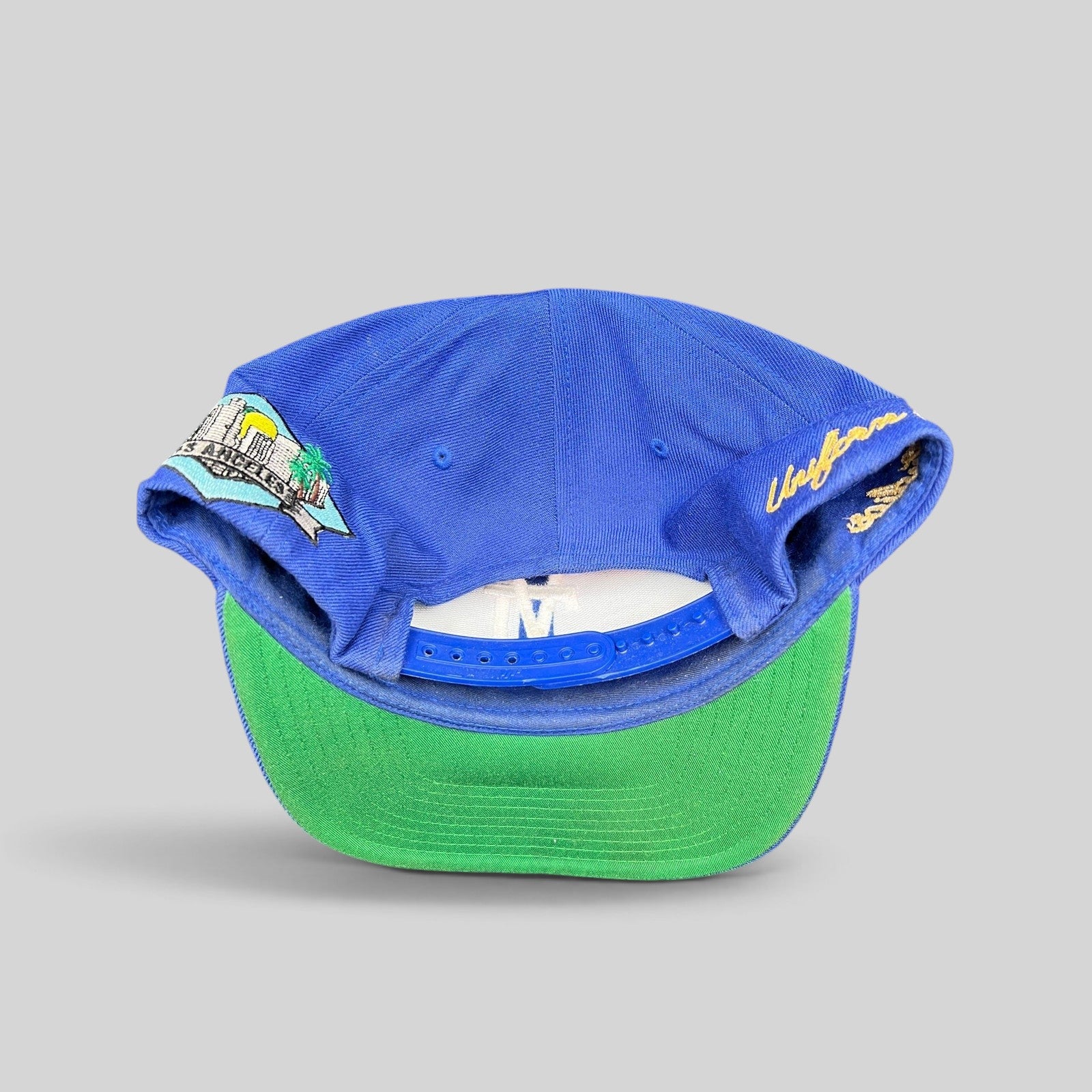 Raree Finds Uniform Studios Los Angeles royal blue snapback hat with green undervisor and city patch detail