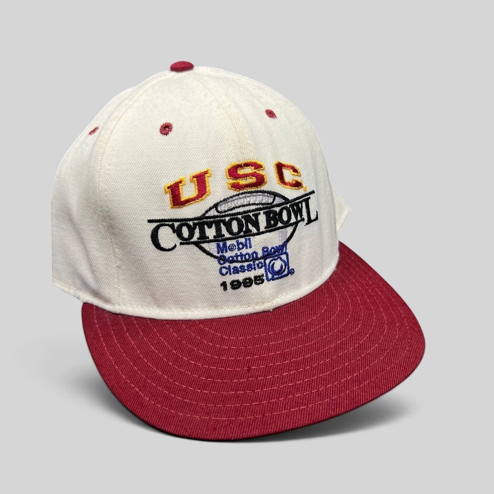 Raree Finds vintage 1995 USC Cotton Bowl snapback hat with white crown, cardinal red brim, and embroidered logo.