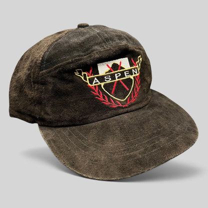 Raree Finds vintage black suede Aspen strapback hat with embroidered crest logo and leather strap closure.