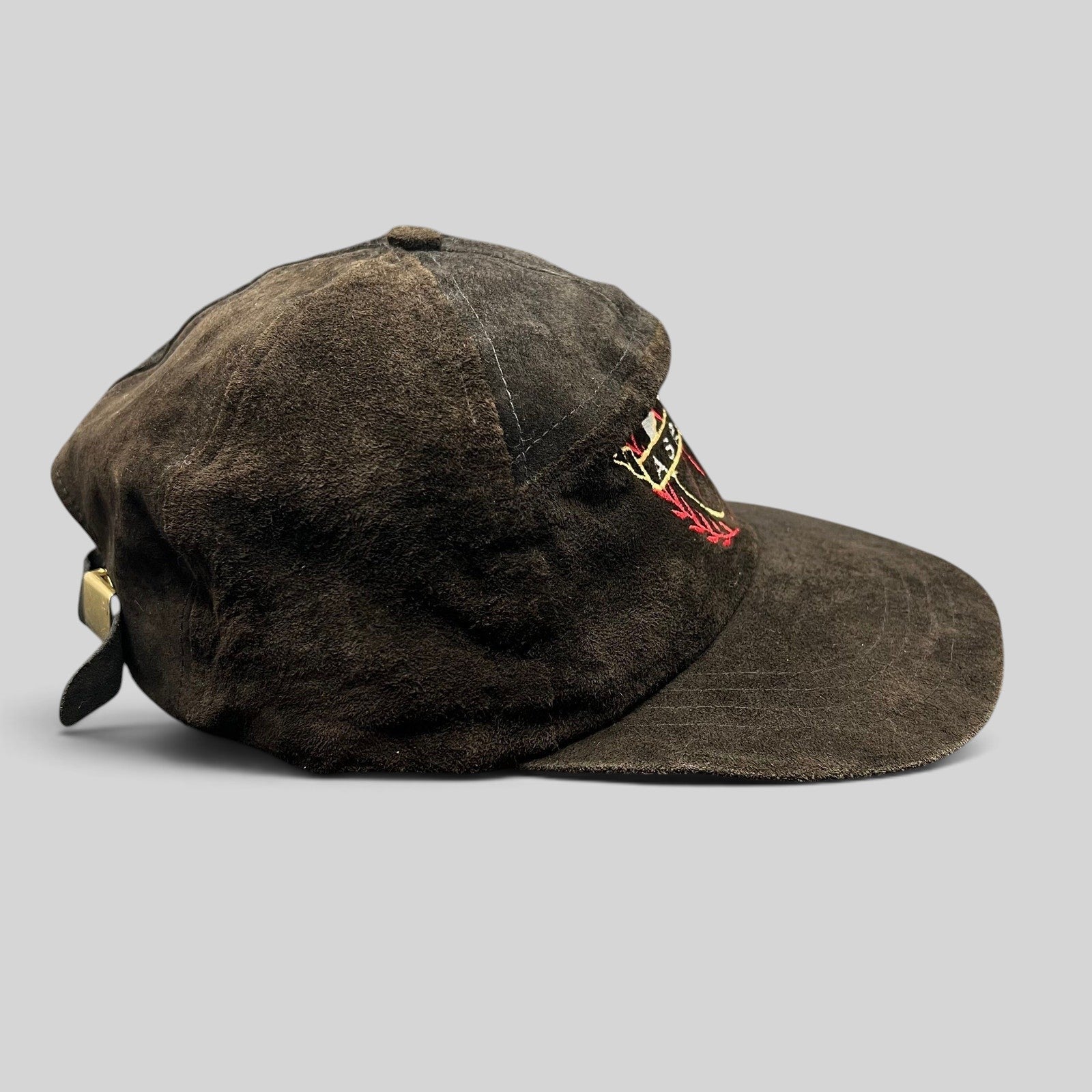 Raree Finds vintage black suede Aspen strapback hat with embroidered crest logo and leather strap closure