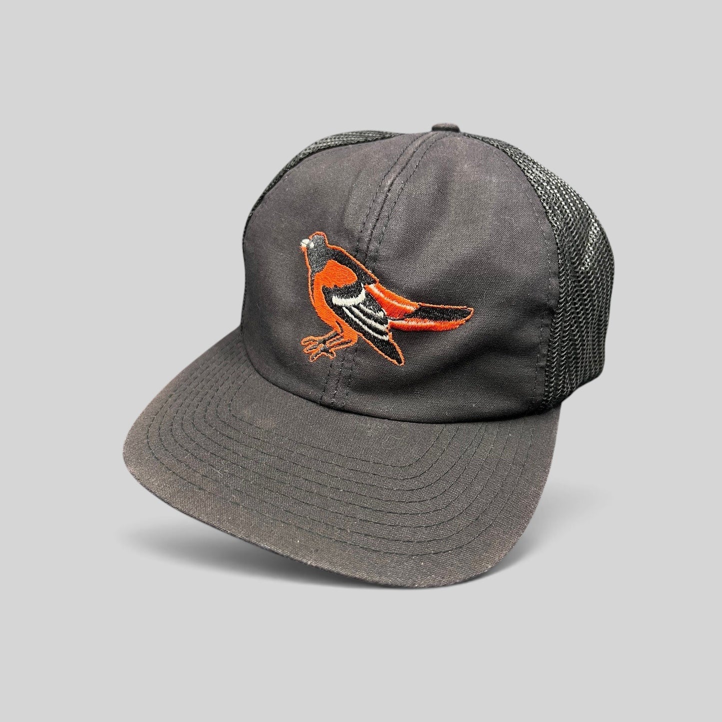 Raree Finds vintage 1980s Baltimore Orioles black mesh snapback hat with embroidered team logo and green underbrim.