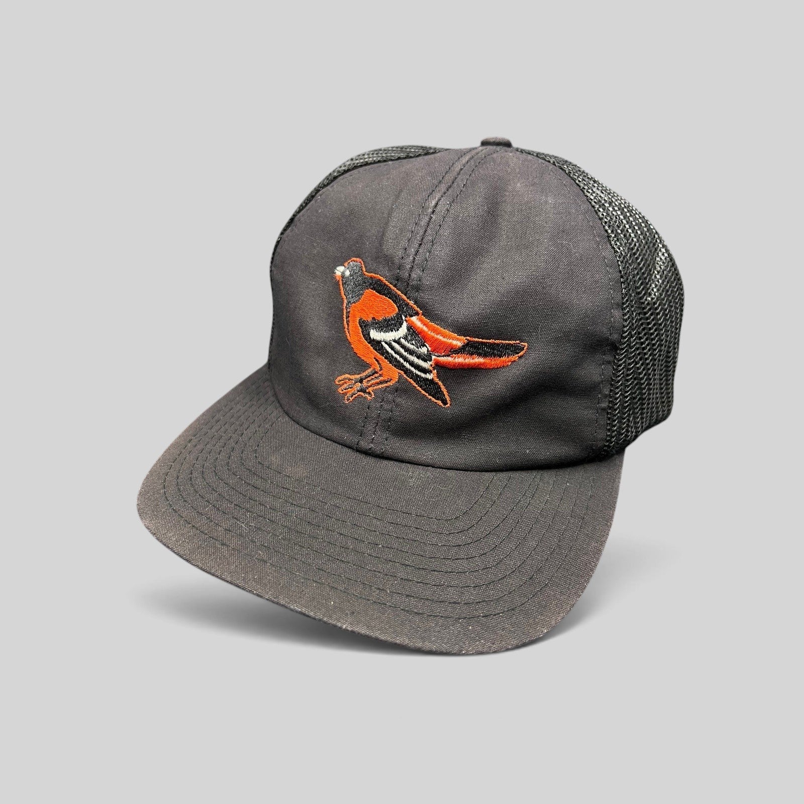 Raree Finds vintage 1980s Baltimore Orioles black mesh snapback hat with embroidered team logo and green underbrim.