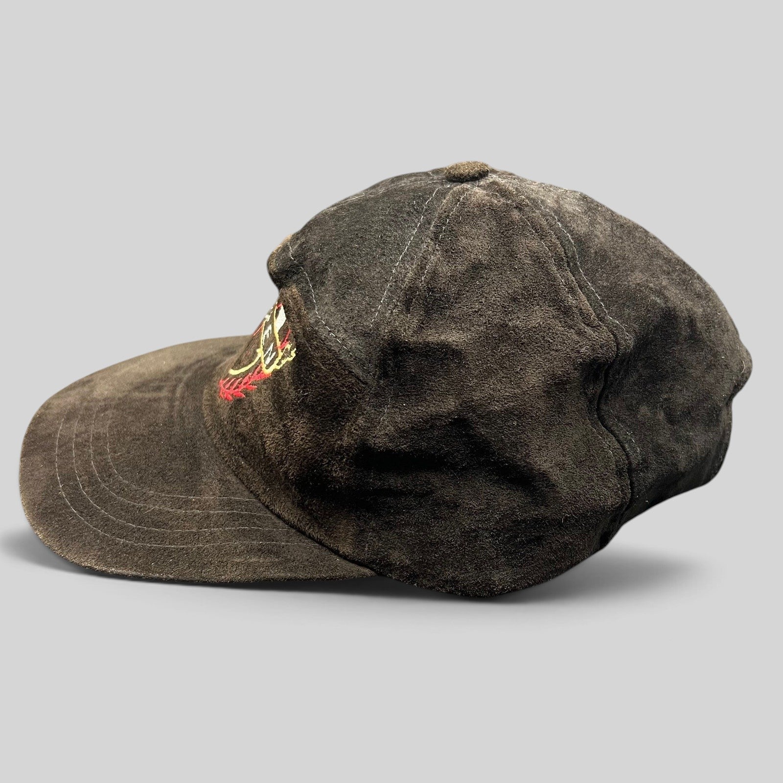 Raree Finds vintage black suede strapback hat with embroidered Aspen crest logo, side profile view.